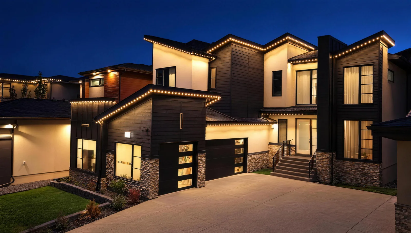 Modern two-storey Calgary home at night with warm white permanent lights along every roofline and garage