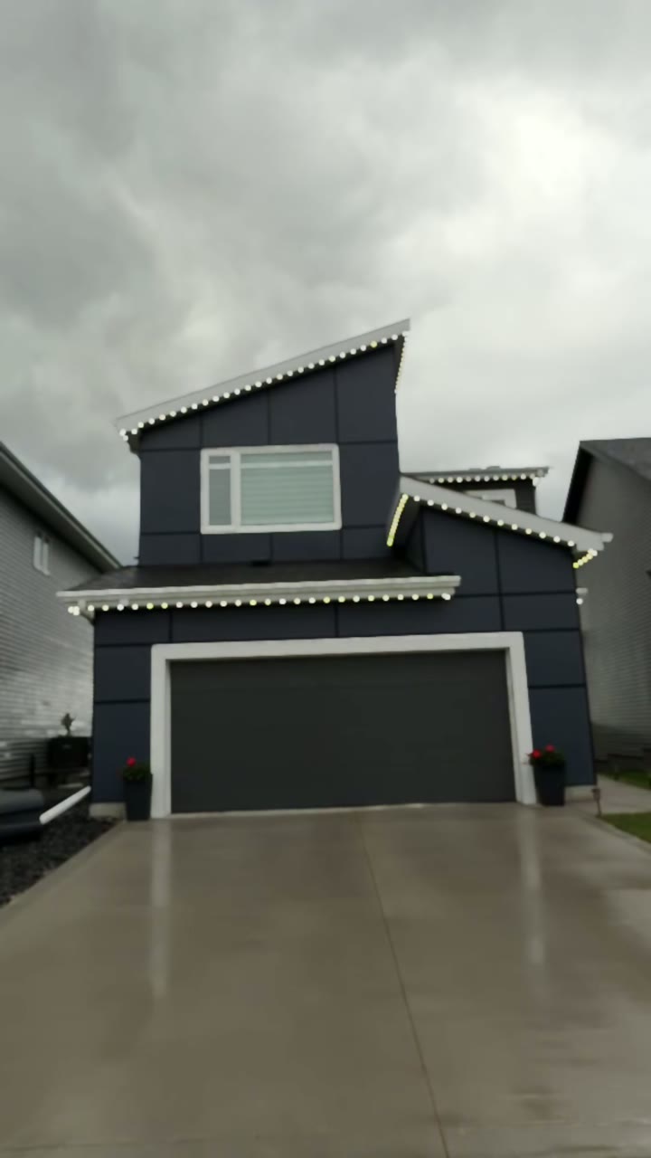 Permanent lighting on a modern Calgary home at night