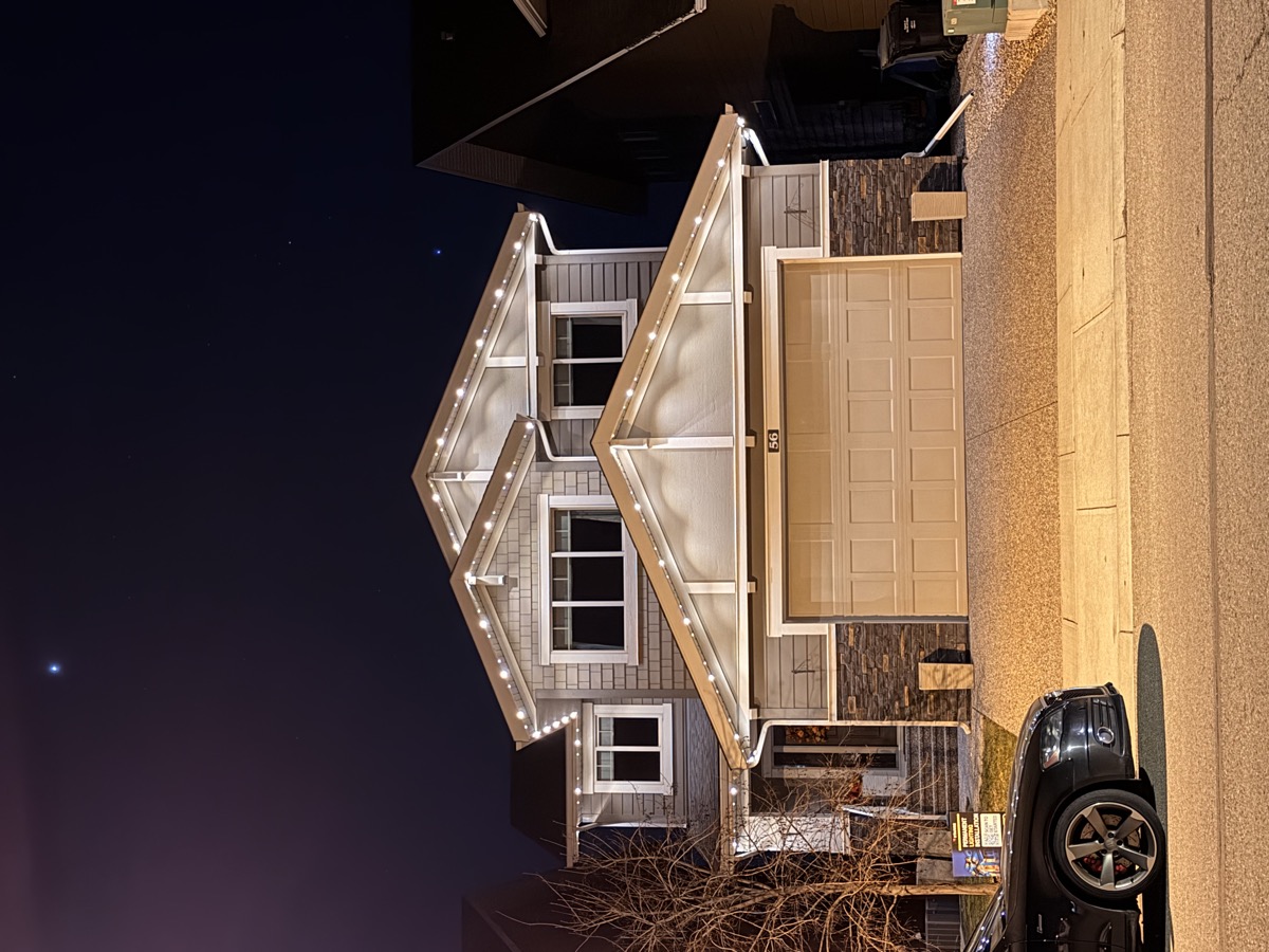 Elegant warm white permanent lighting on Calgary home with double garage