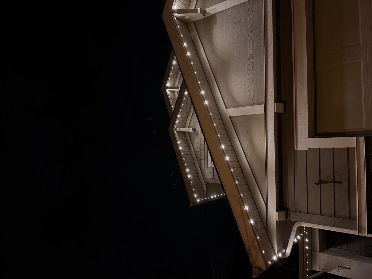 Cool white permanent LED roofline lights on contemporary Calgary residence
