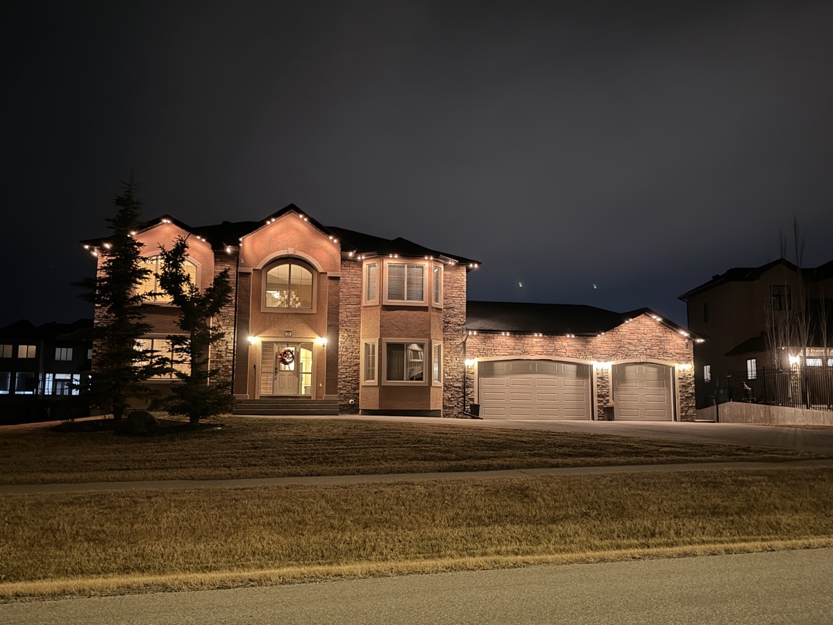 Starise permanent LED lighting installation on Calgary home with peaked roofline