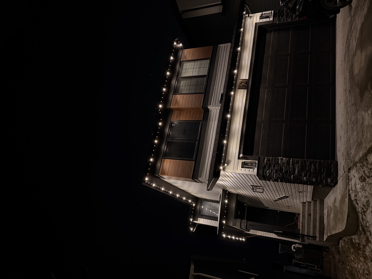 Permanent outdoor roofline lighting on Calgary estate-style home