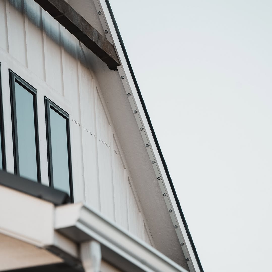 Warm white permanent accent lights illuminating craftsman-style Calgary home exterior