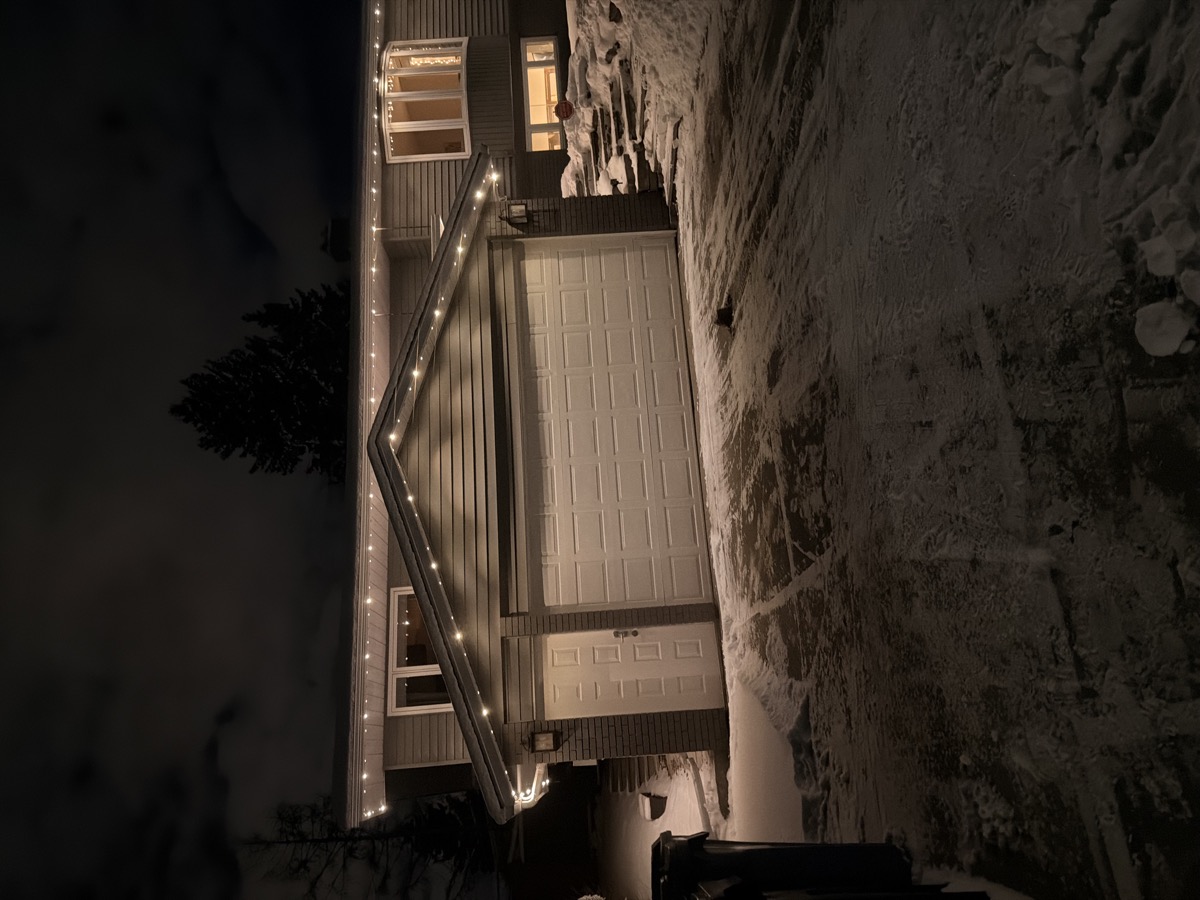 Permanent warm white outdoor lighting enhancing curb appeal on Calgary home