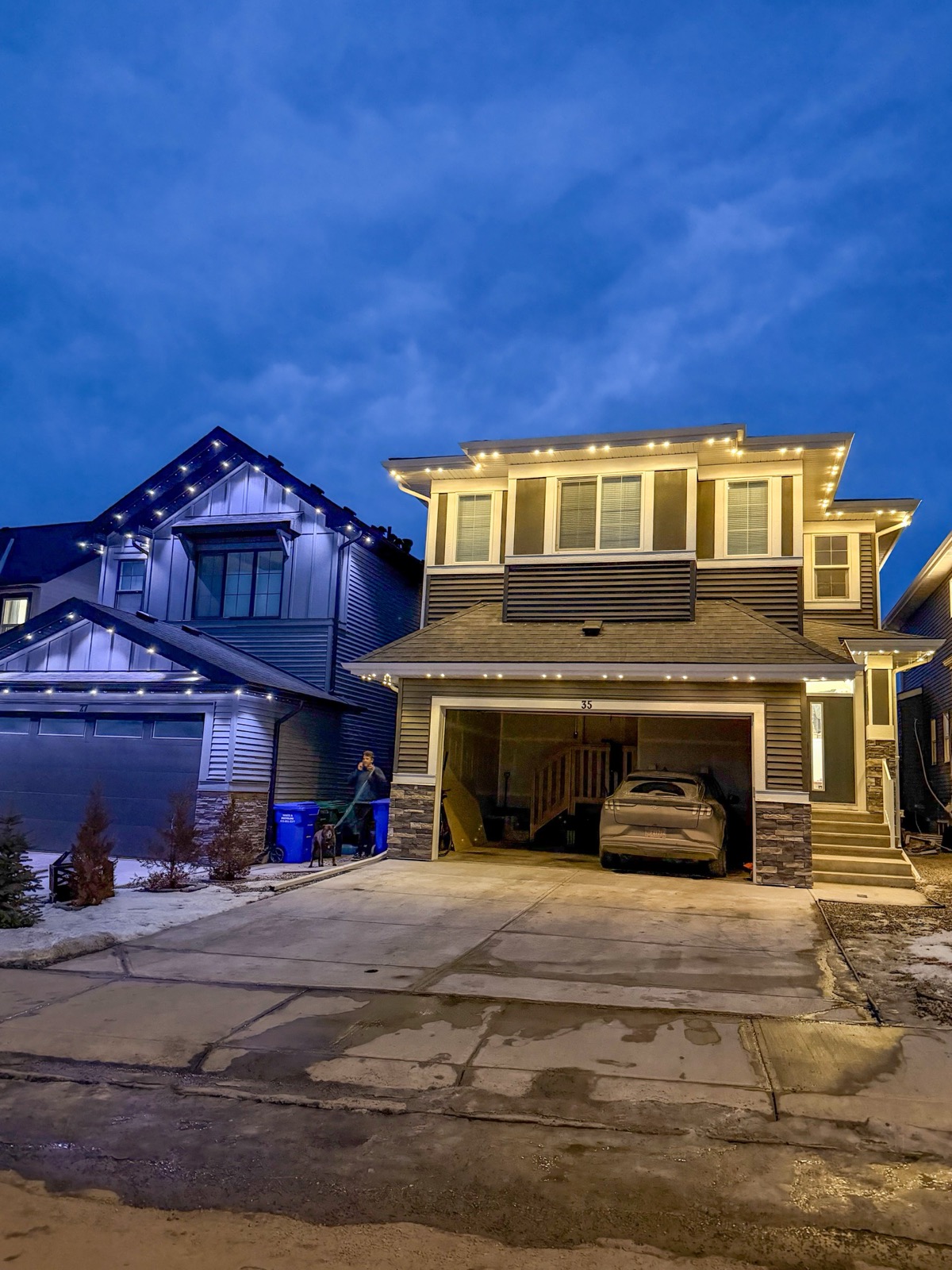Permanent LED roofline lights casting soft glow on Calgary home siding