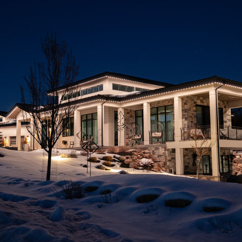 Permanent LED roofline and fascia lighting on Calgary home at nighttime
