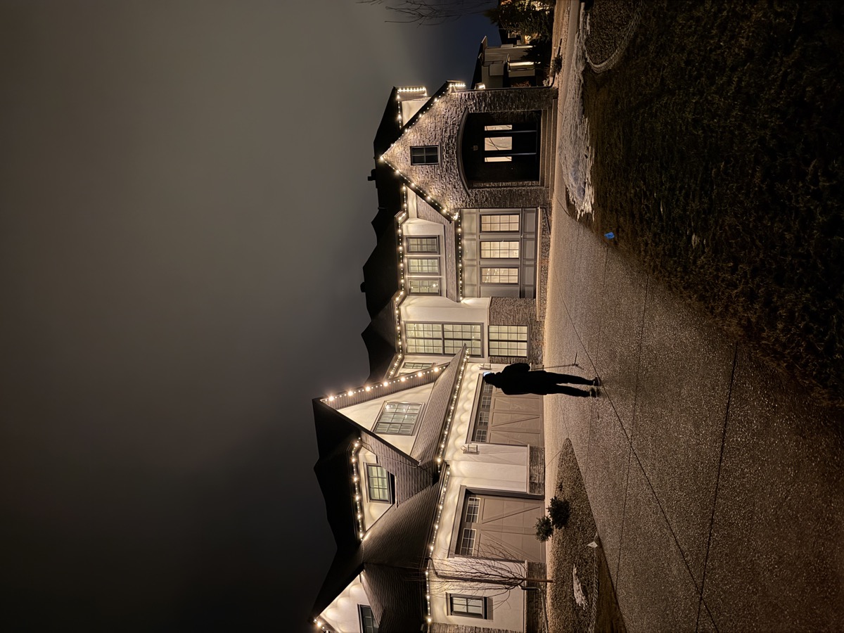 Permanent LED accent lighting framing windows and roofline on Calgary home