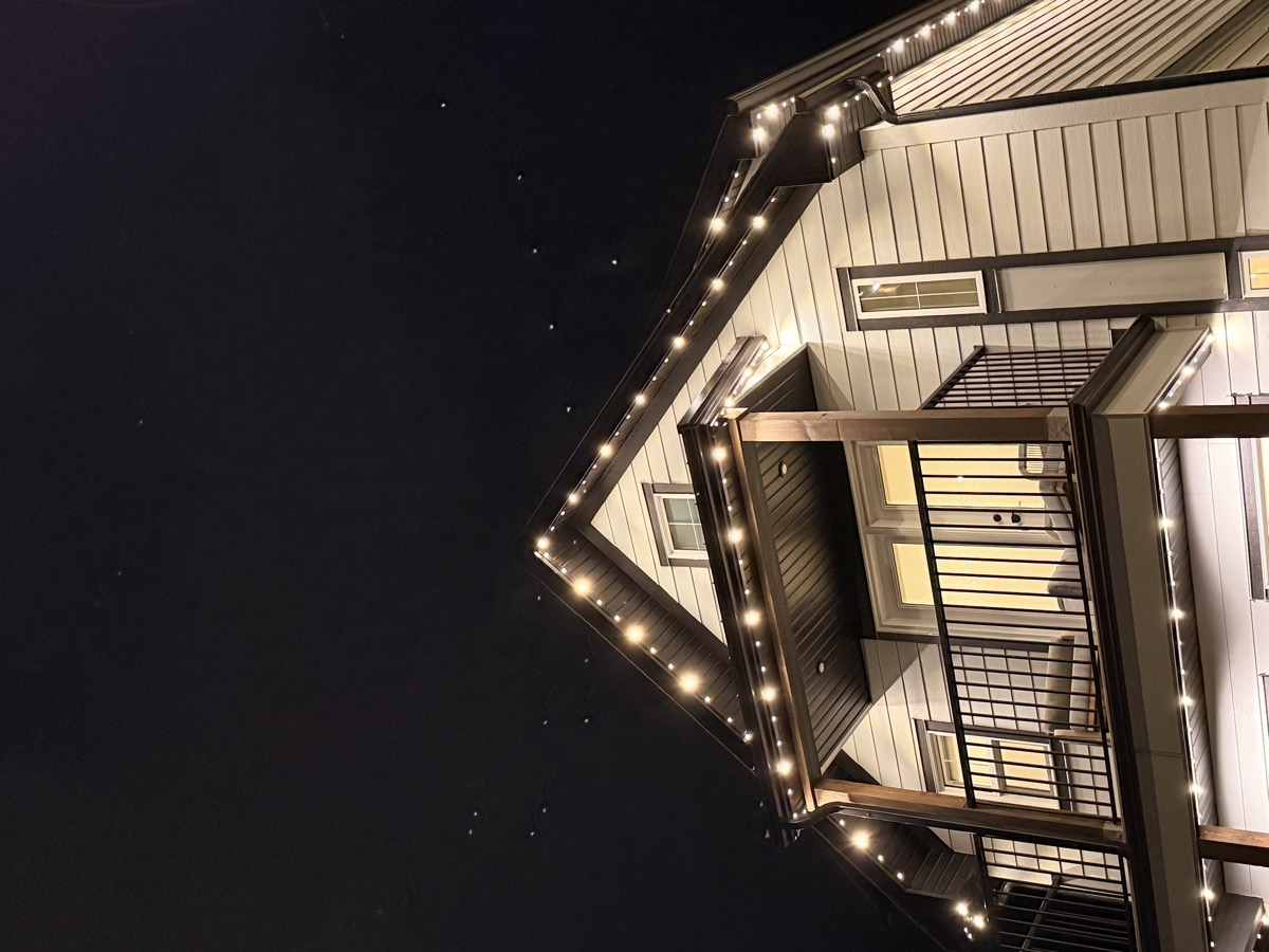 Bright permanent LED roofline lights on Calgary corner-lot home