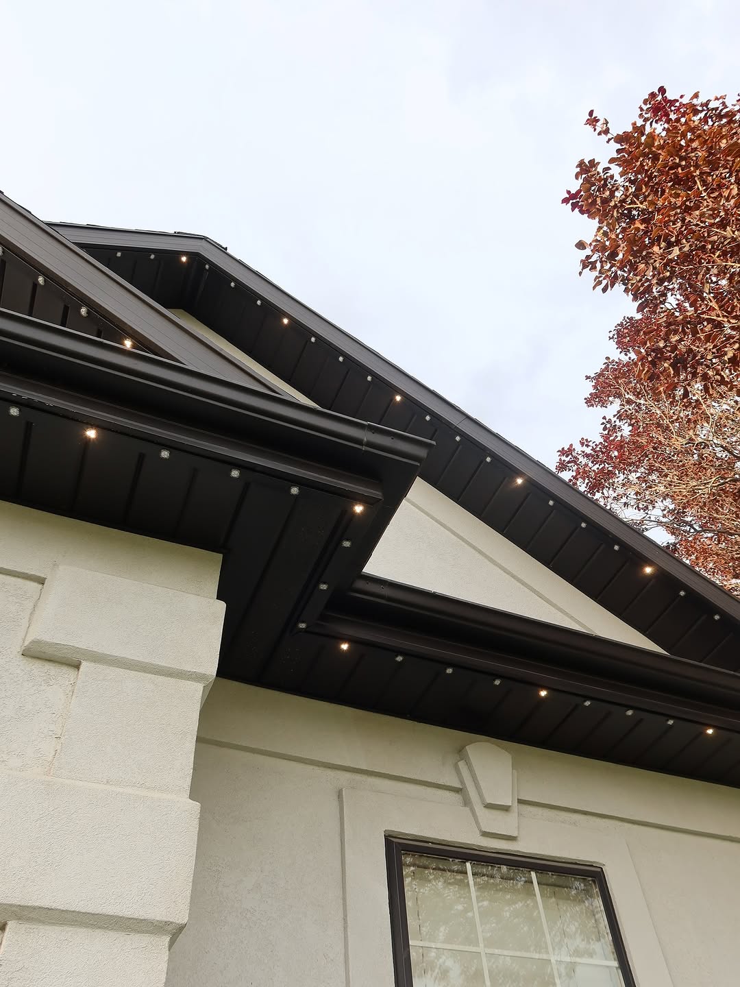 Permanent outdoor LED lights highlighting front entrance and garage roofline in Calgary