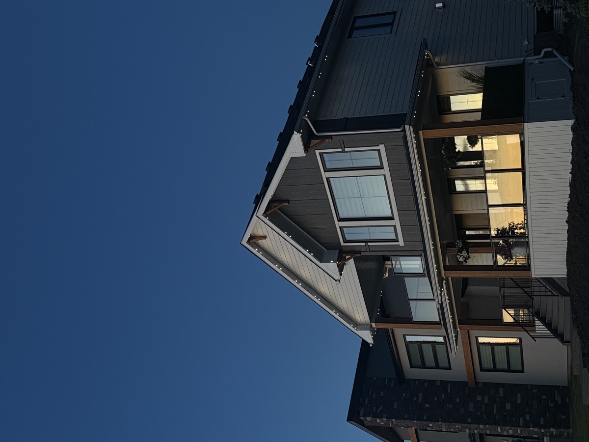 Permanent roofline lighting providing warm glow on Calgary family home