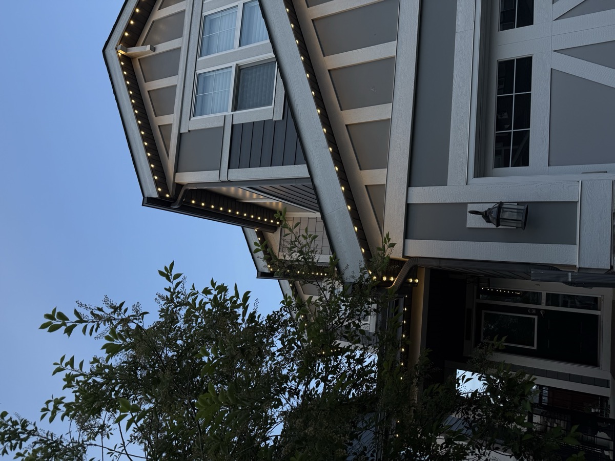 Permanent LED accent lights on Calgary home with brick and stucco exterior