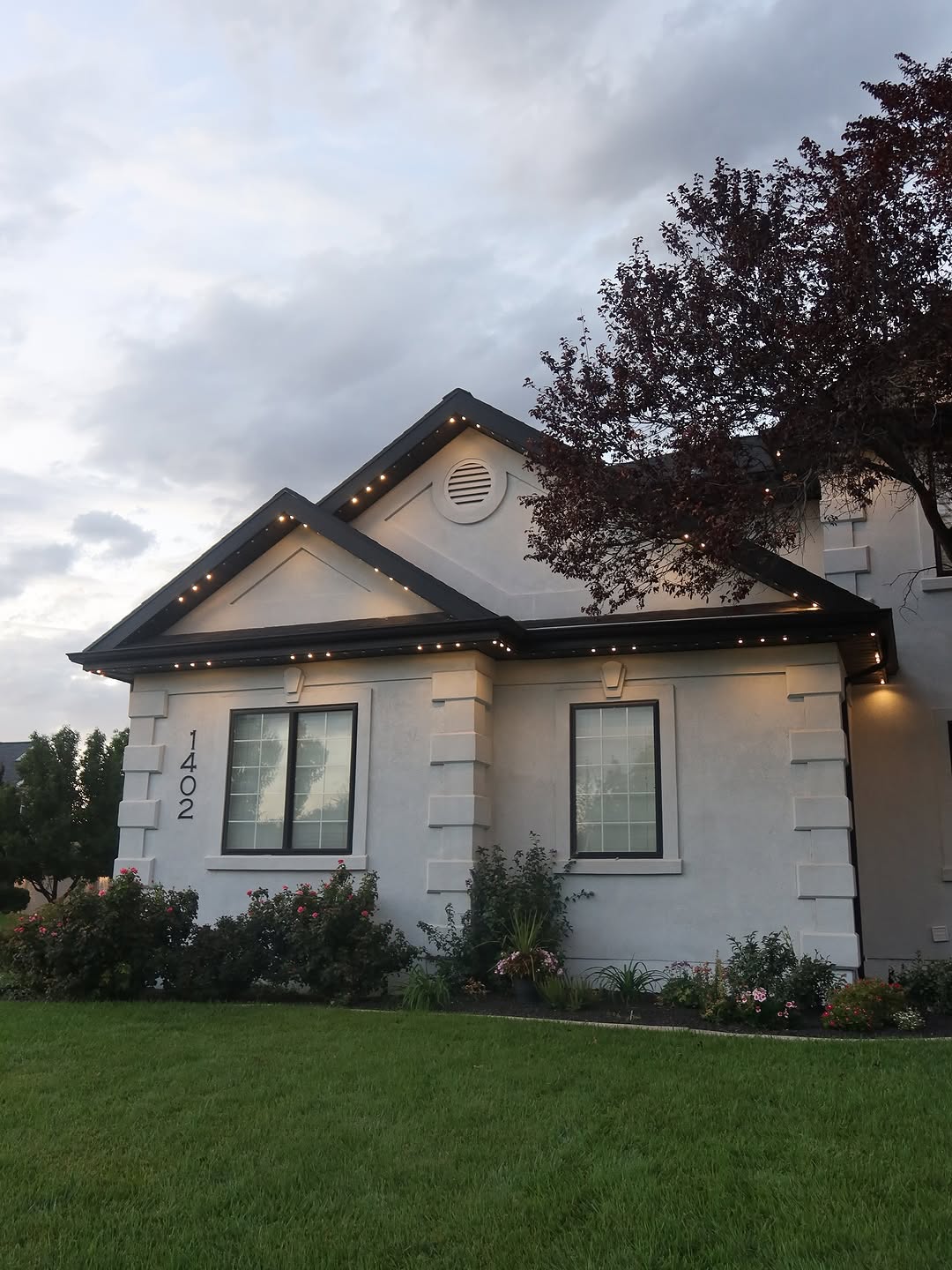 Ice blue permanent LED accent lights on Calgary home during winter evening