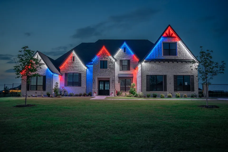 Home lit in red and blue scenes along each gable