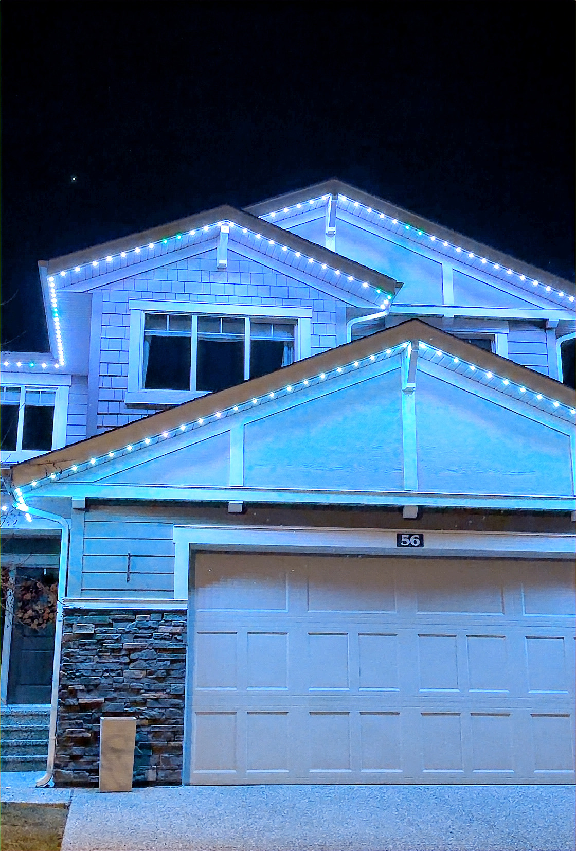 Permanent LED accent lights in patriotic red and white on Calgary home