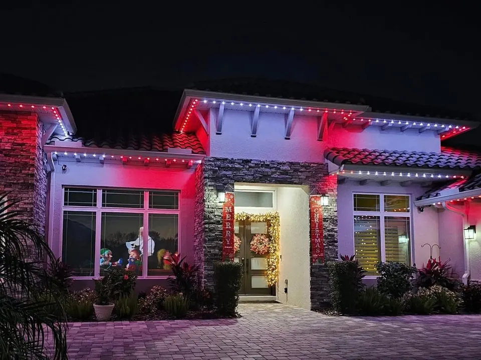 Modern Calgary home with permanent lighting set to red and pink along the soffits