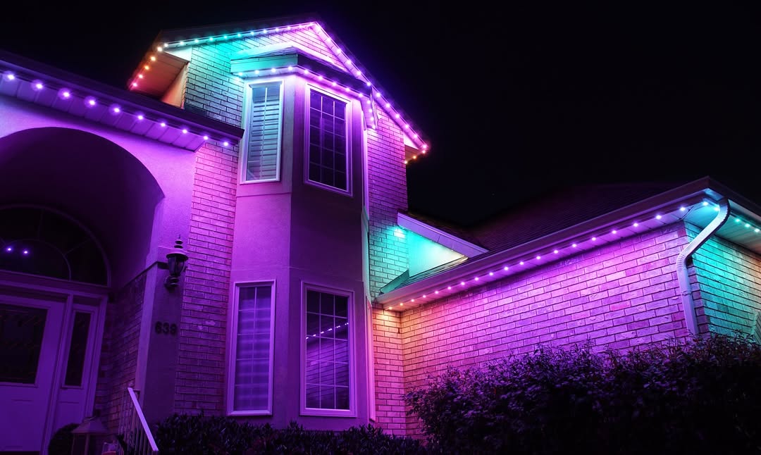 Permanent roofline lights in orange and black for Halloween on Calgary home