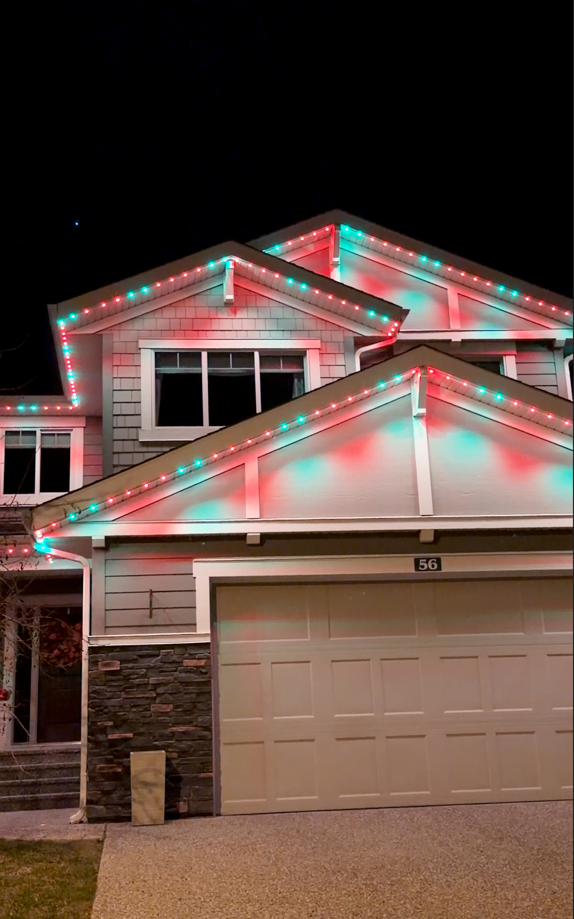 Festive permanent lighting display with twinkling effects on Calgary home