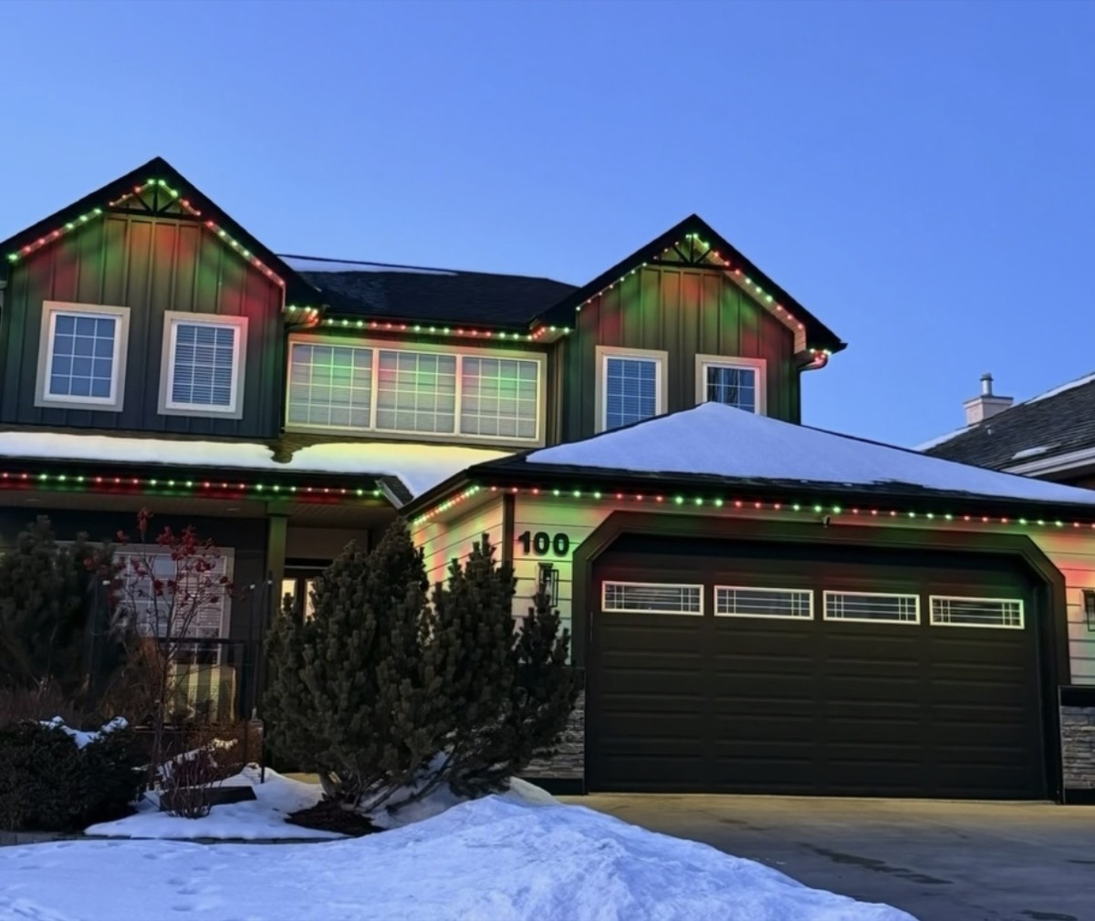 Warm permanent holiday lighting creating cozy winter ambiance on Calgary home