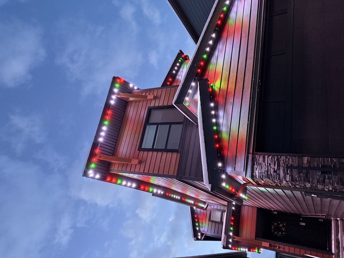 Warm white permanent holiday lights creating classic Christmas look on Calgary home