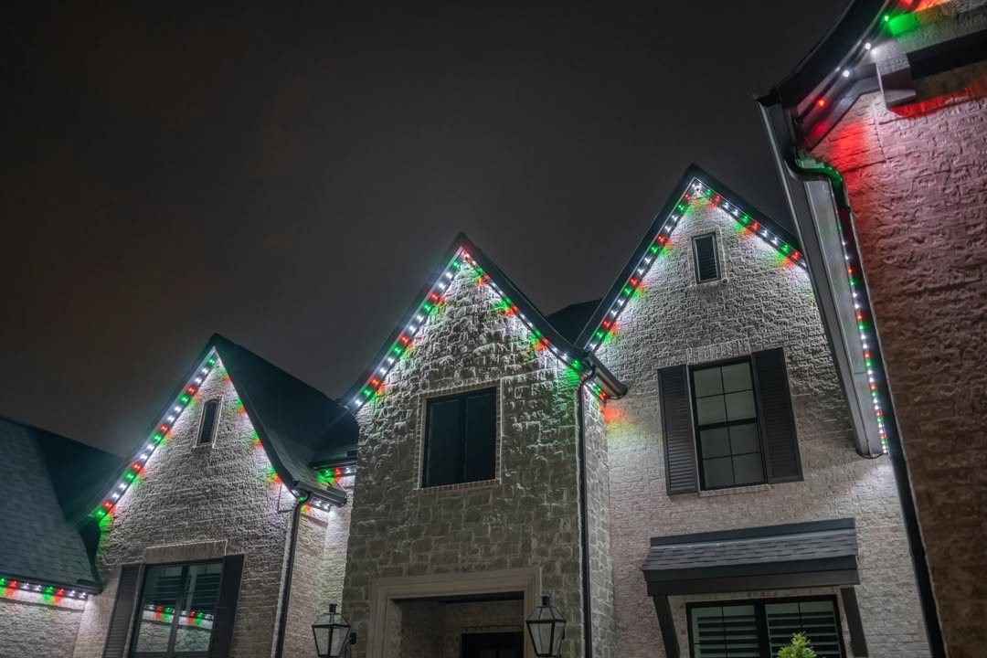 Bright permanent Christmas lighting display on Calgary home with snow-covered roof