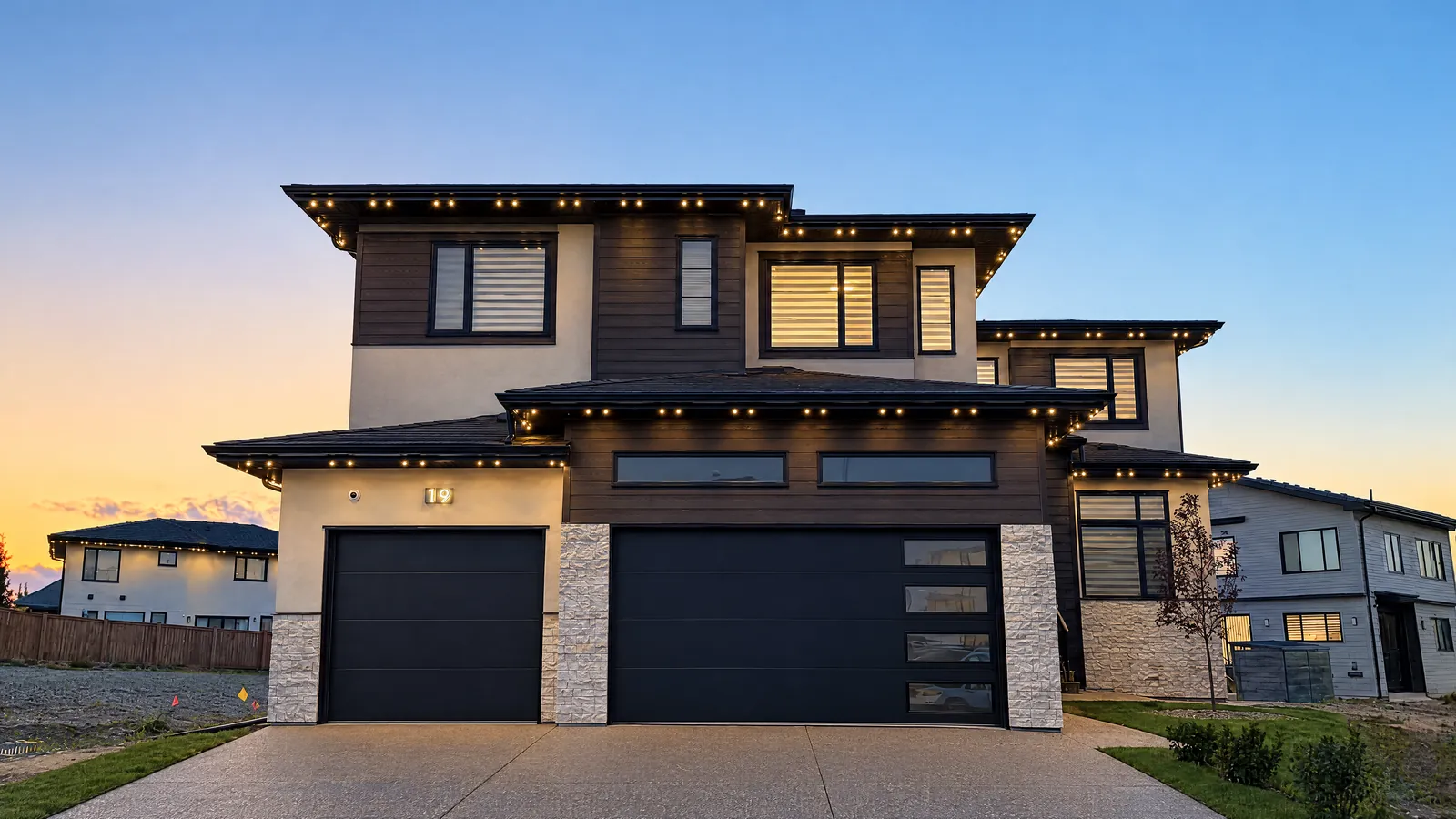 Modern two-storey home at dusk with warm white permanent lighting under every eave