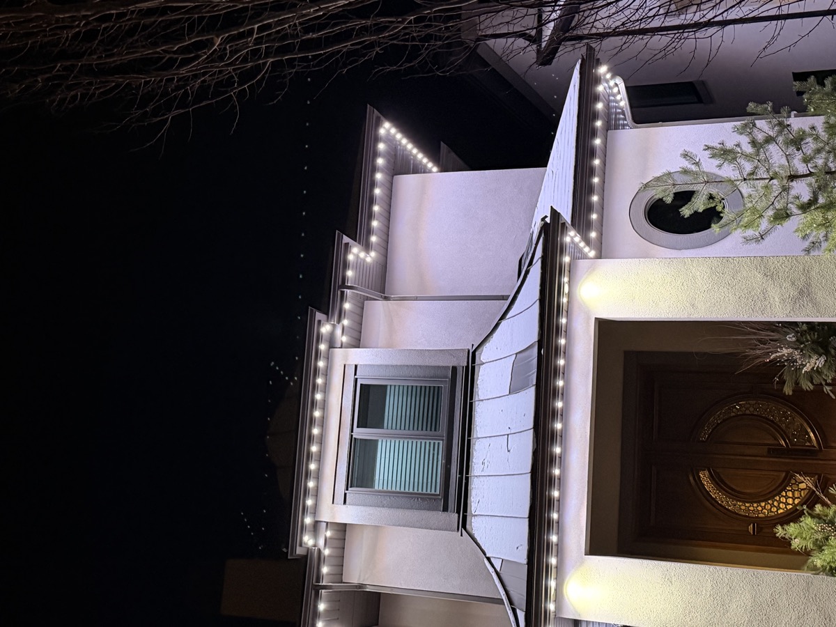 Bright white permanent LED security lighting illuminating Calgary home perimeter