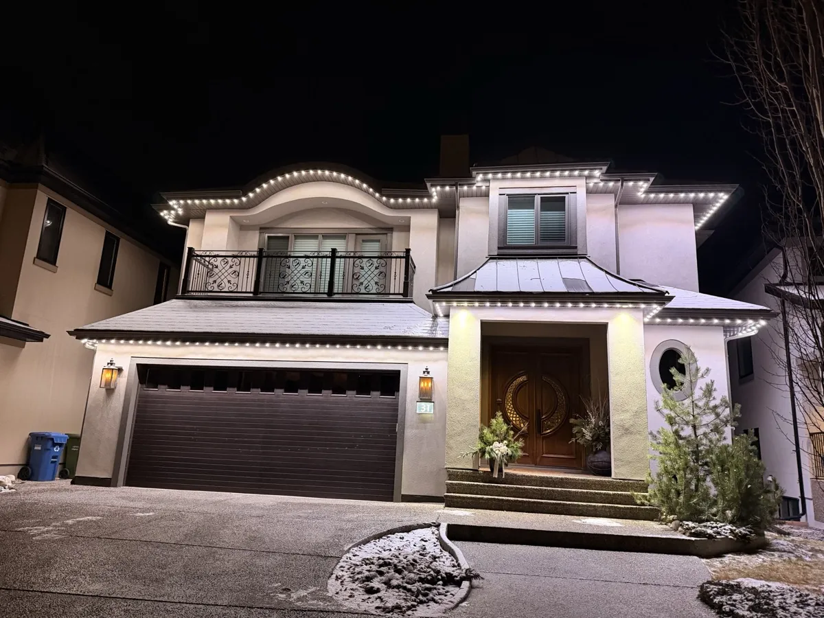 Bright white permanent lighting across a two-storey home at night