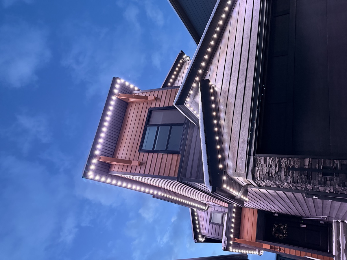 Permanent roofline security lights providing bright downward illumination on Calgary home