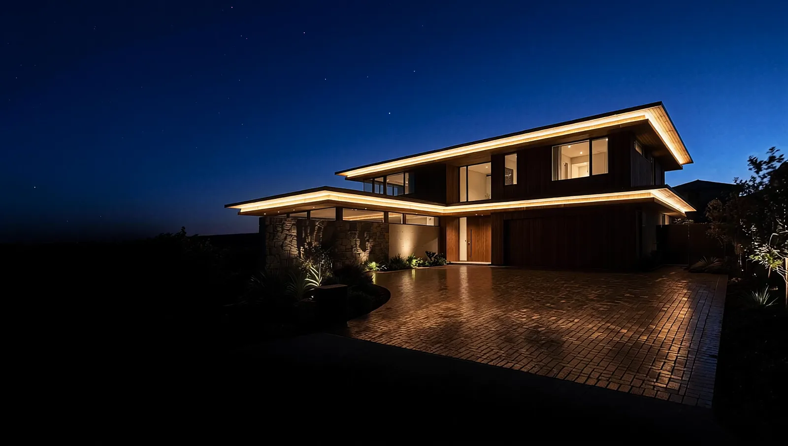 A modern home at blue hour, its rooflines traced in warm white Starise lighting